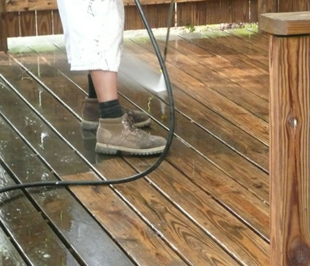 technician performing professional deck cleaning before staining in northern new jersey