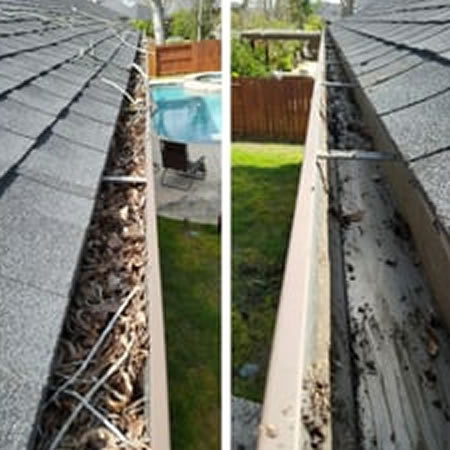 Technician performing gutter cleaning NJ on a two-story home